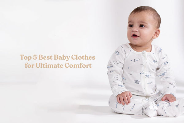 Baby in white zip-up onesie with blue sea creature prints sitting on white background