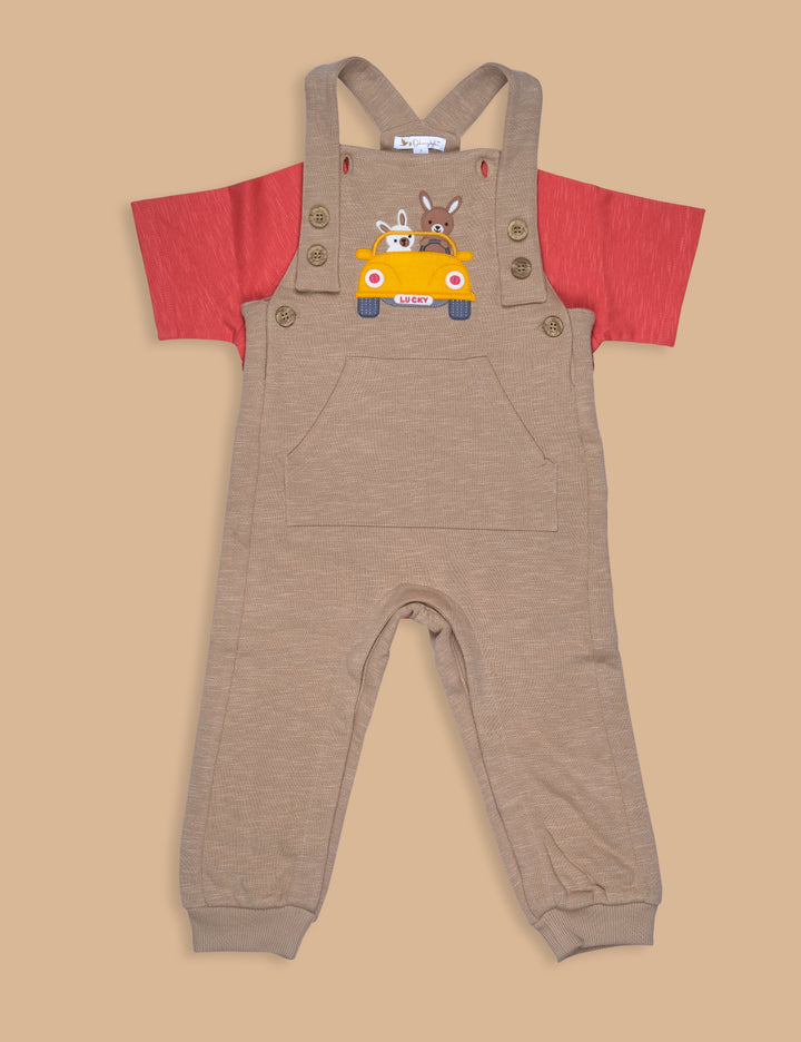 A set of children's clothing consisting of a red jersey tee and beige overalls with a pocket on the chest.
