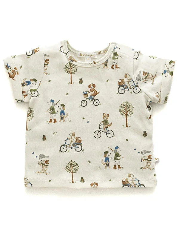 Cream organic cotton baby boy tee with animal print featuring dogs riding bikes and walking with nets