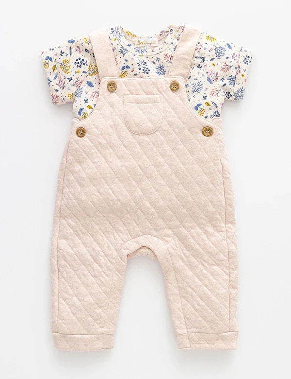 Baby outfit with pink quilted dungarees and floral short-sleeve cotton shirt