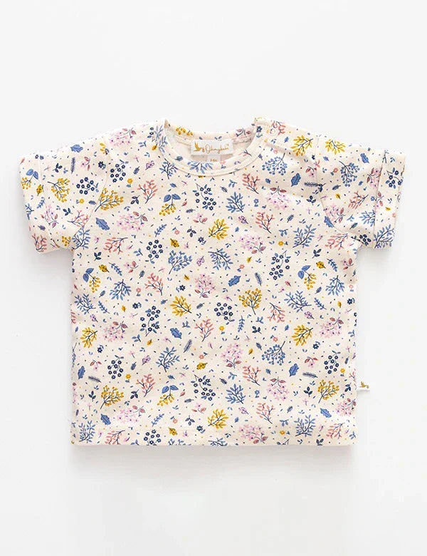Baby organic cotton tee with colorful floral print in yellow, pink, and blue on white background