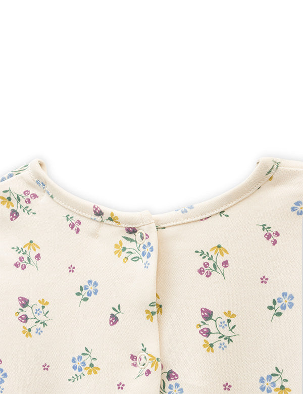  Back snap button closure detail on cream floral baby romper.   