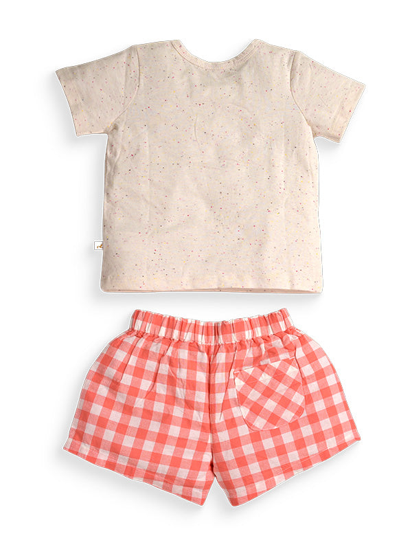 Back view of children's outfit with cream speckled short sleeve t-shirt and red gingham check shorts with elastic waist and pocket
