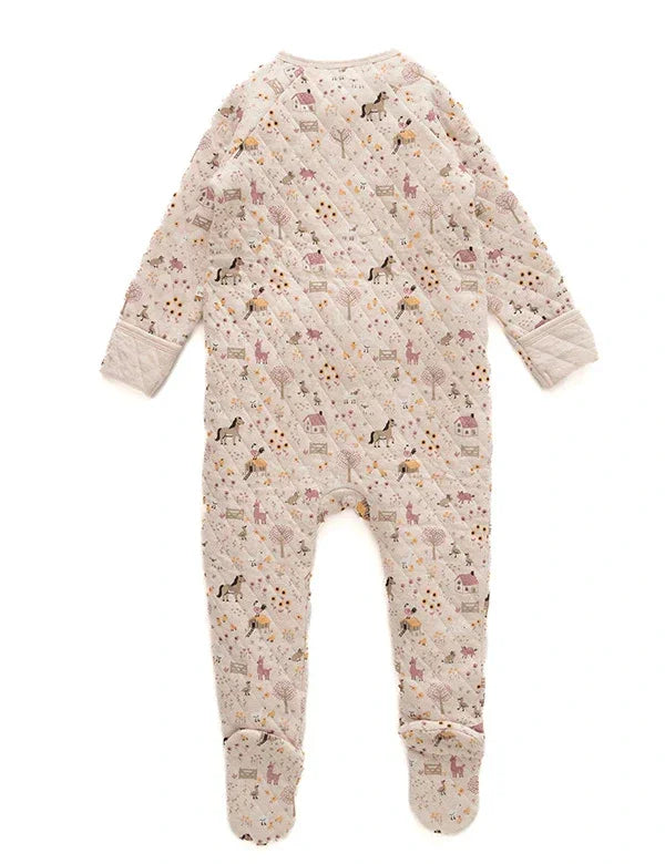 Back view of beige quilted baby romper with animal and tree print, long sleeves, and footed legs