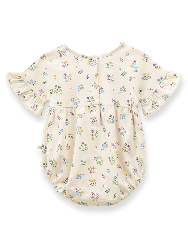Back view of floral ruffle baby romper made from soft organic cotton.