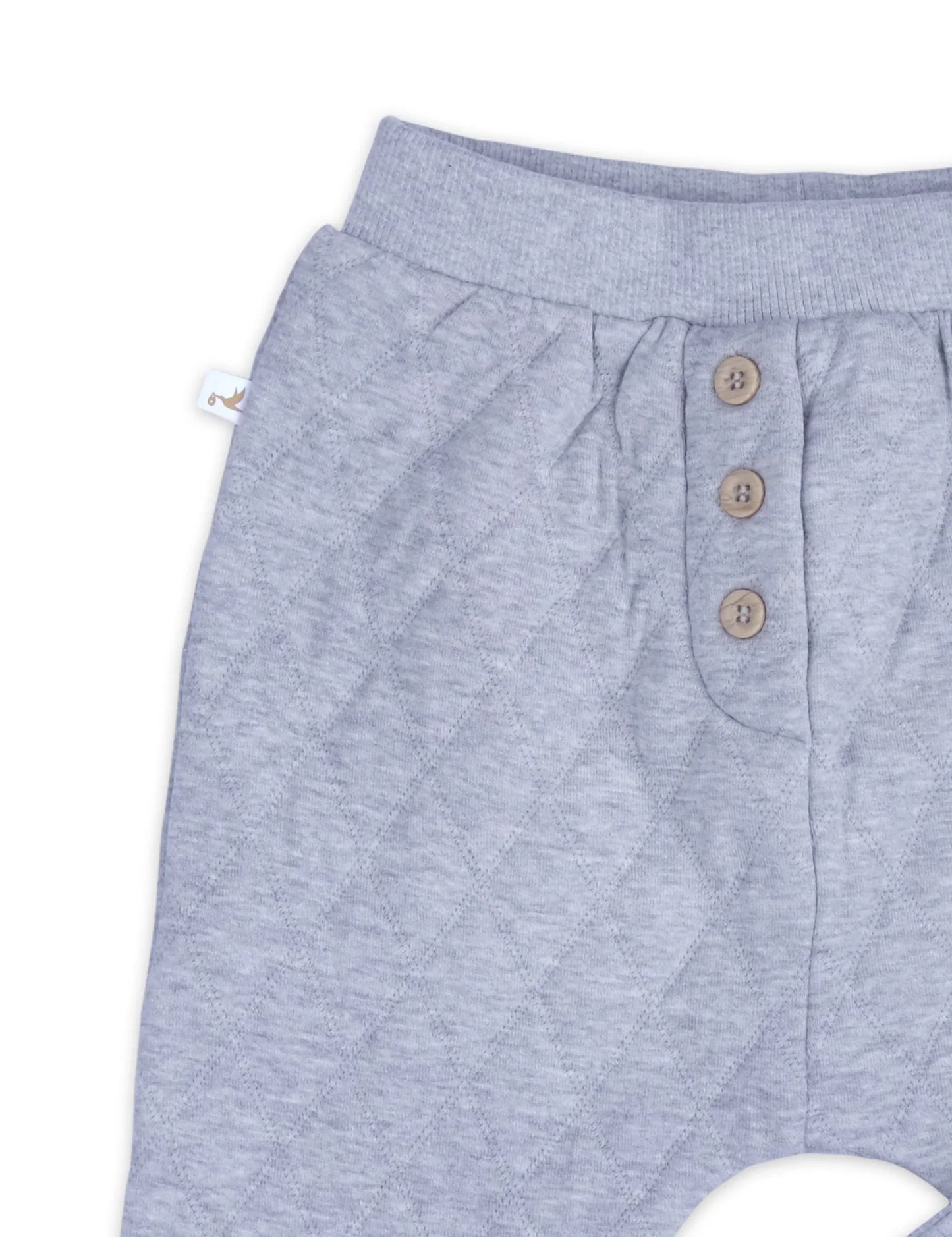Back view of grey melange quilted slouchy track pants with three wooden buttons and ribbed waistband