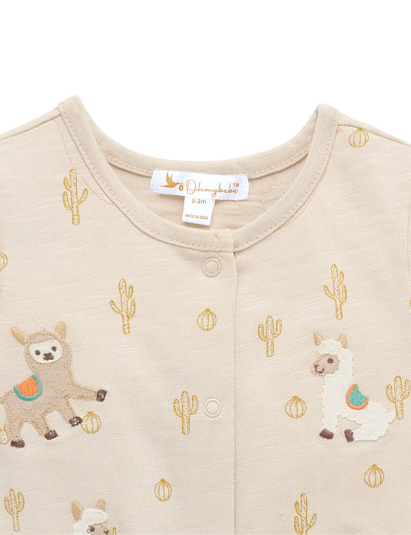 Beige baby romper with embroidered cute llamas and cactus patterns, front snap closure