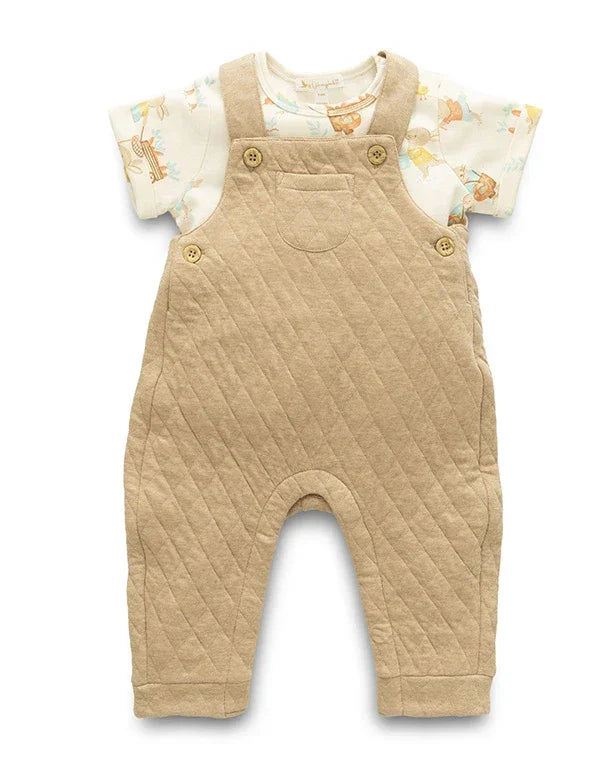 Beige quilted baby romper with a white shirt featuring animal prints on a white background