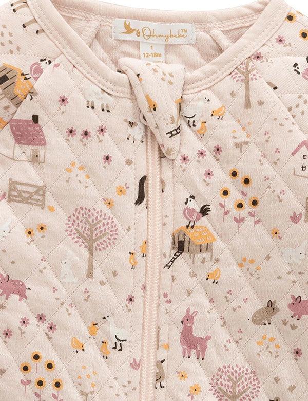close-up of beige quilted baby romper with farm animal and tree prints, size 12-18 months