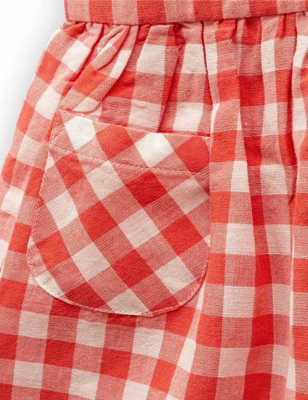  Close-up of coral gingham dress pocket detail in breathable cotton-linen fabric