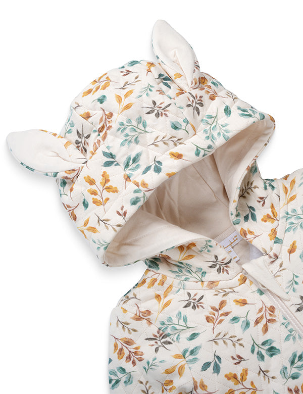 Close-up of floral print baby romper with hood and cute fabric ears in soft autumn colors