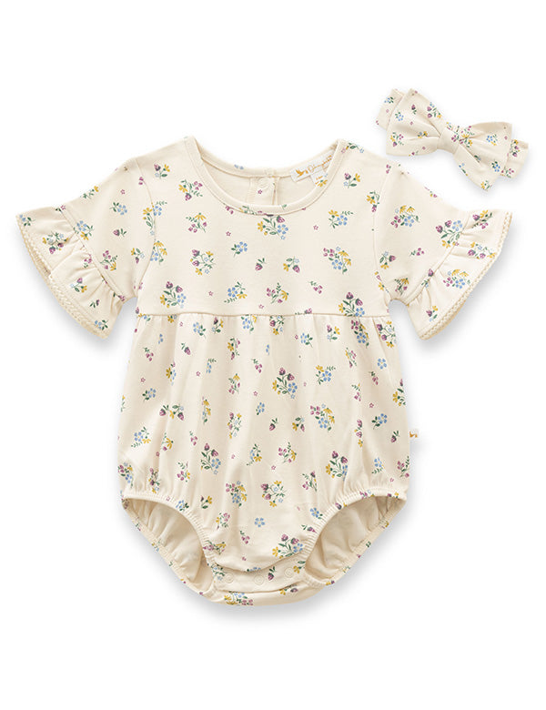 Cream floral ruffle baby romper with matching headband made from 100% organic cotton.