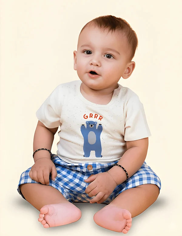 Organic cotton baby clothes set with speckled bear-print T-shirt and blue gingham shorts.