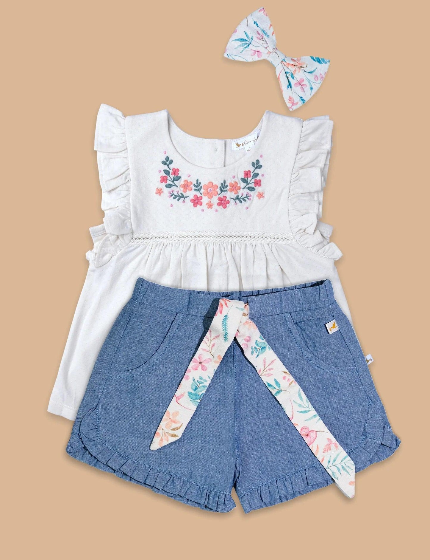 Organic cotton baby dress set with embroidered floral white top, blue shorts with floral belt, and matching floral headband