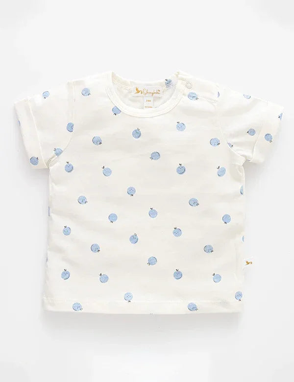 White baby t-shirt with small blue fruit print, short sleeves, and shoulder snap buttons