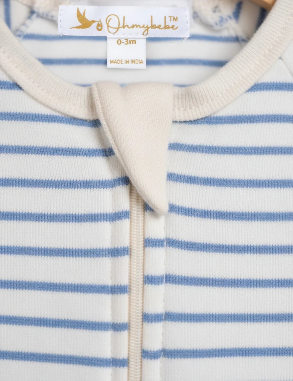 Close-up of a baby outfit with blue and white stripes and a visible brand label.