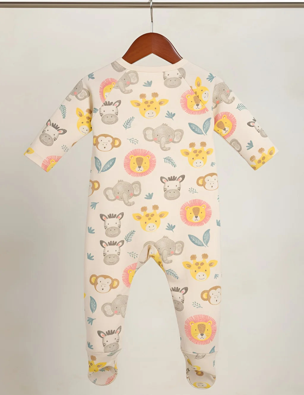 Children's onesie with animal pattern on a hanger against a white background