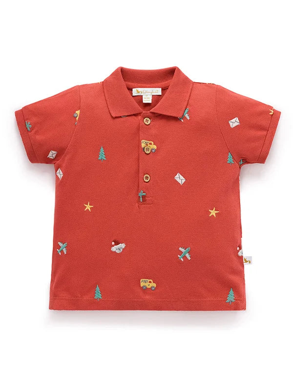 Red polo shirt with colorful patterns on a white background