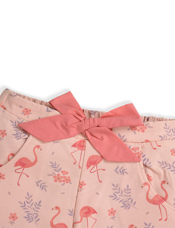 Pink fabric with flamingo and floral print featuring a tied coral-pink bow detail