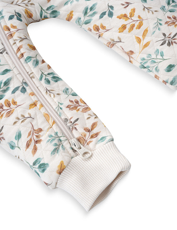 Close-up of two-way zipper and ribbed cuffs on floral quilted organic cotton baby romper – easy diaper change design