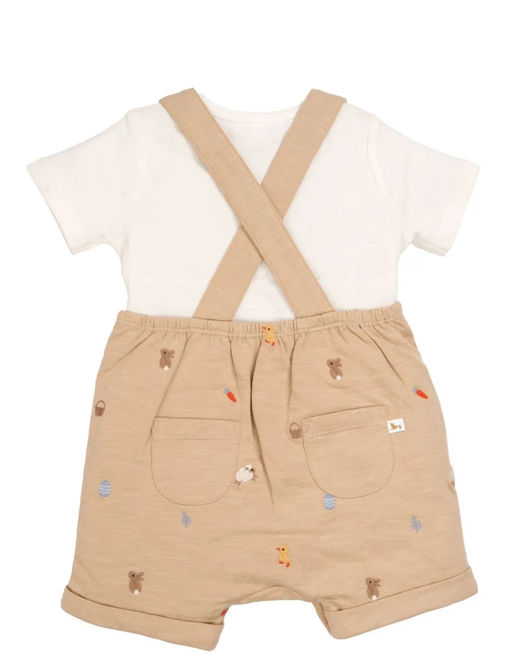 Back view of beige organic cotton baby dungaree set showing cross straps and pockets.