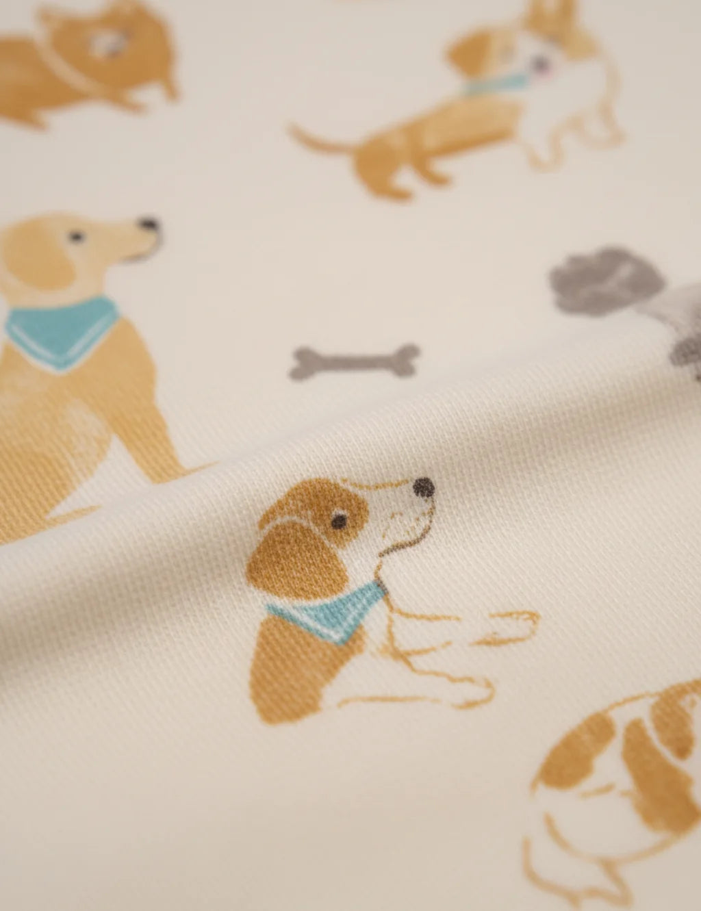 Fabric with embroidered dogs and bones pattern on a beige background