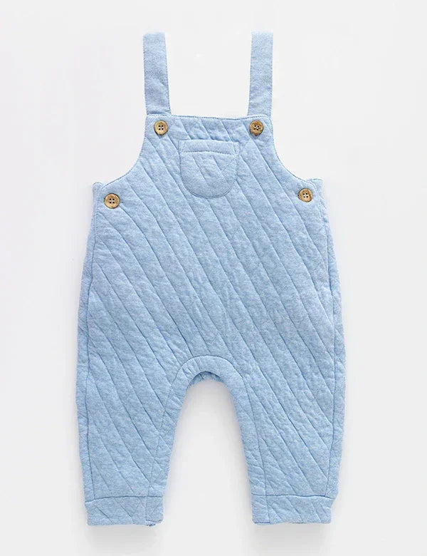 Soft blue quilted baby dungarees with wooden buttons and strap details on white background