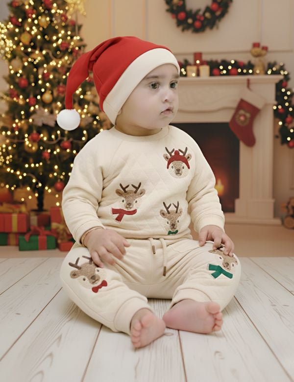 Child wearing a Christmas-themed outfit with reindeer designs in a festive room.