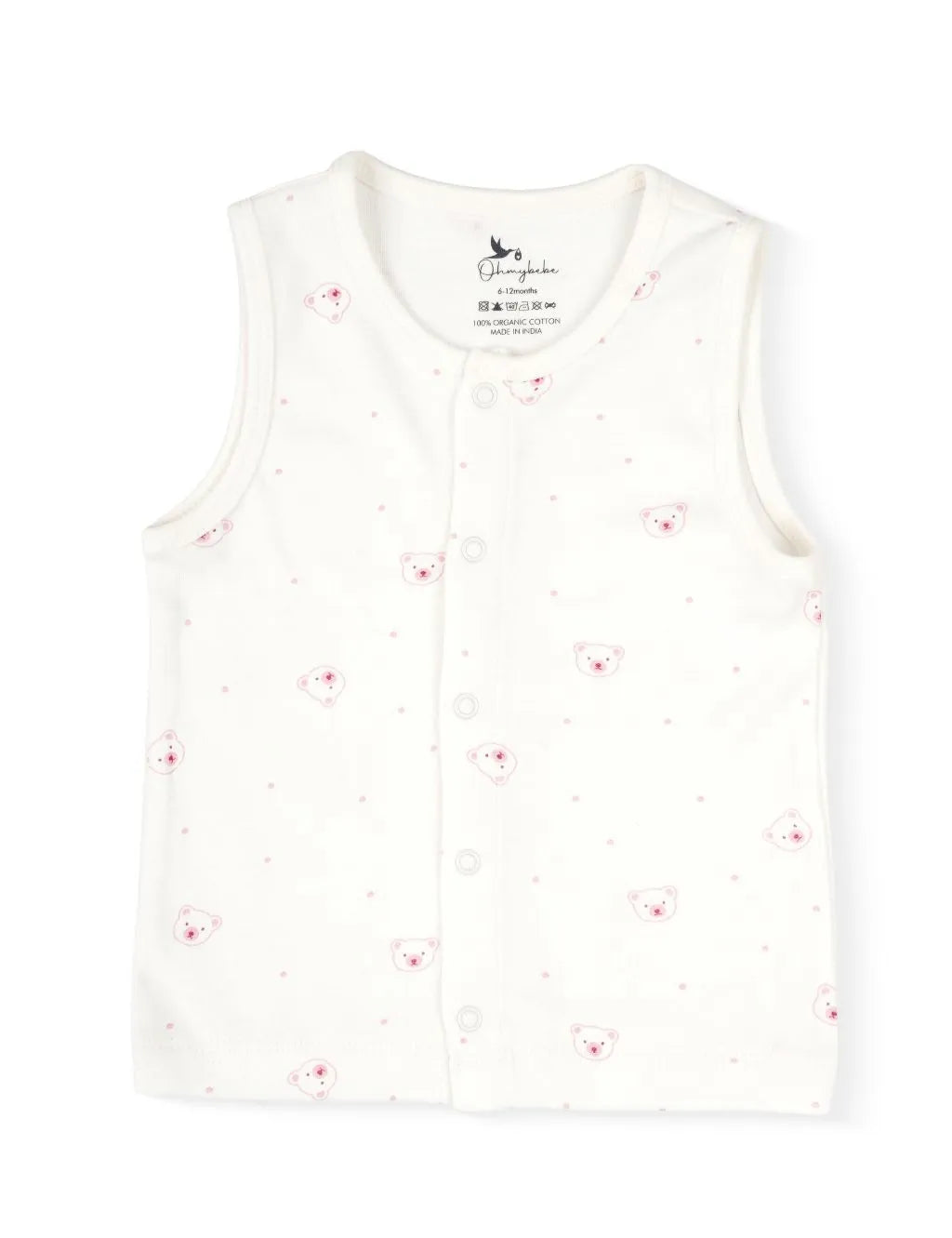 A sleeveless cream-colored baby tank top featuring a delicate scattered pattern of tiny pink dots and small bear faces with pink cheeks. The top features a full-length front snap-button closure and clean stitched trim along the neck and armholes, laid flat against a plain white background.