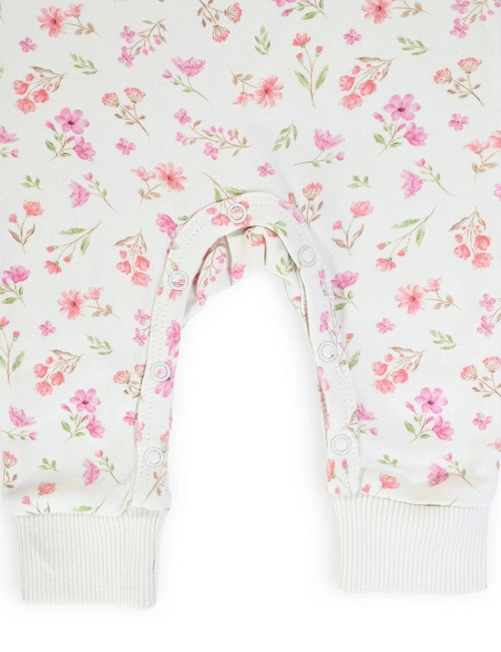 Close-up showing the convenient bottom snap closures and ribbed ankle cuffs designed for easy diaper changes on the floral printed organic cotton baby growsuit.