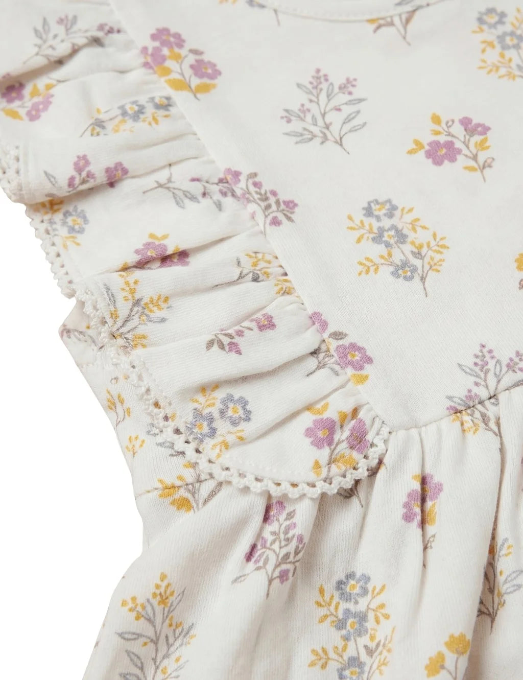Close-up shot of cream floral print toddler dress highlighting flutter sleeve ruffles and delicate lace trim