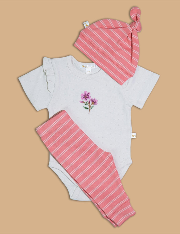 Set includes a white baby bodysuit with floral embroidery, pink and white striped leggings, and a matching knotted baby hat. Buy stylish baby outfits India.