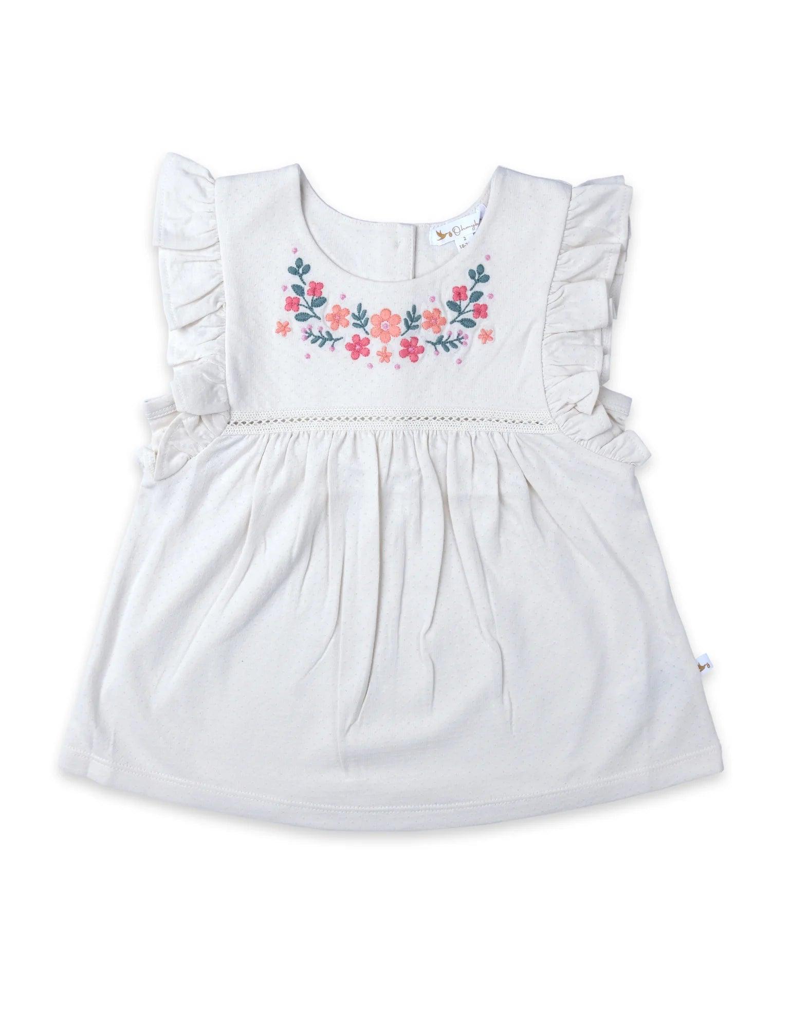 White baby ruffle tunic top with pink and orange floral embroidery on chest