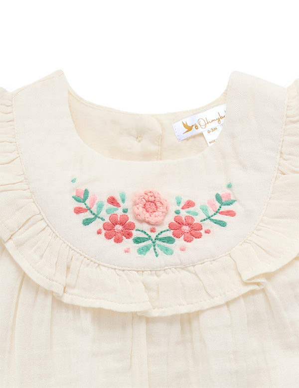 Cream baby girl top with floral embroidery and ruffled neckline detail