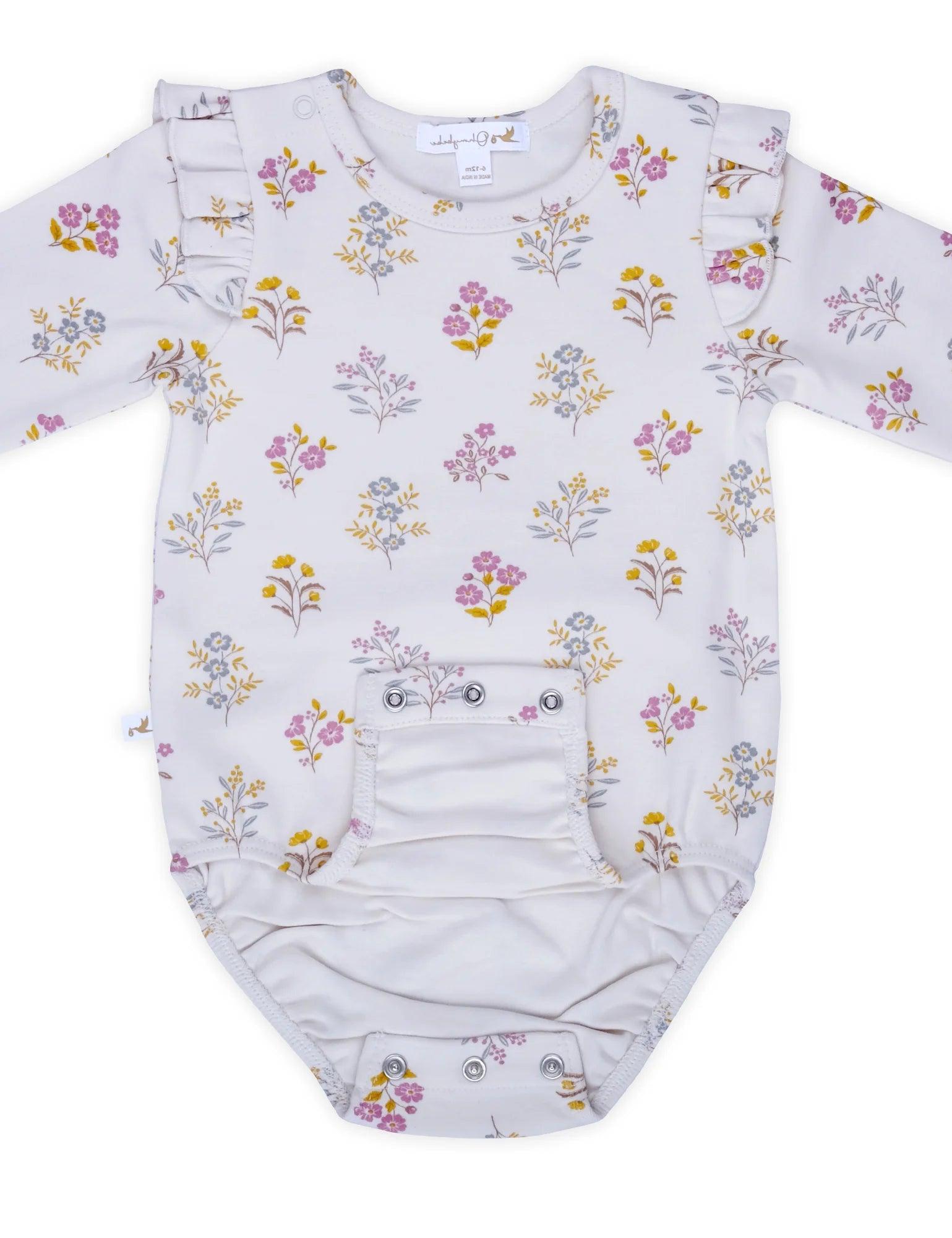 White organic cotton baby bodysuit with yellow, pink, and blue floral print and ruffle sleeves