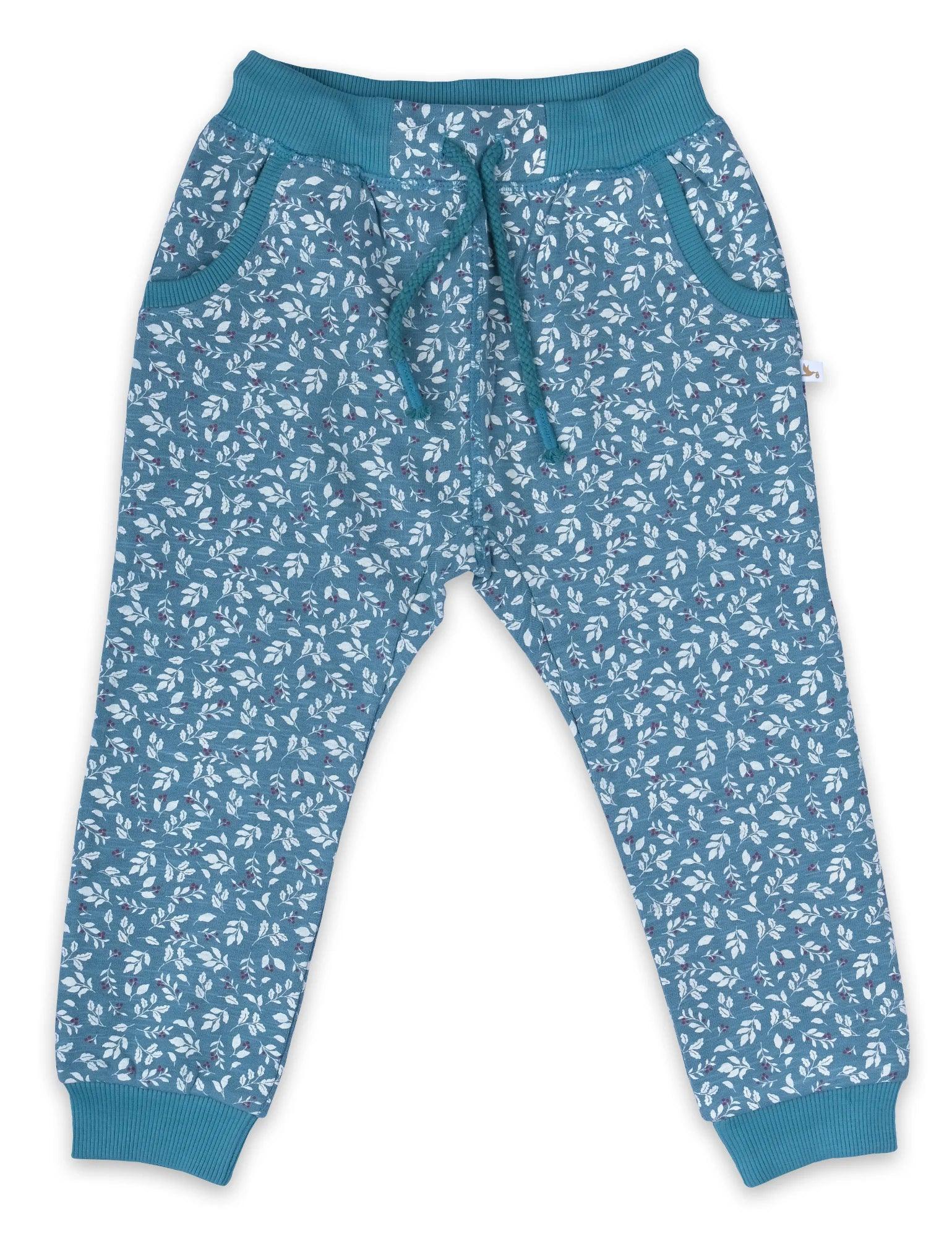 Blue organic cotton baby pants with white leaf floral print and teal ribbed cuffs and waistband