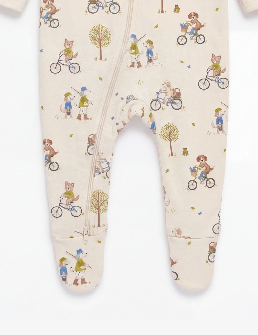 Close-up of the footed legs on an organic cotton baby zipper romper with bicycle prints.