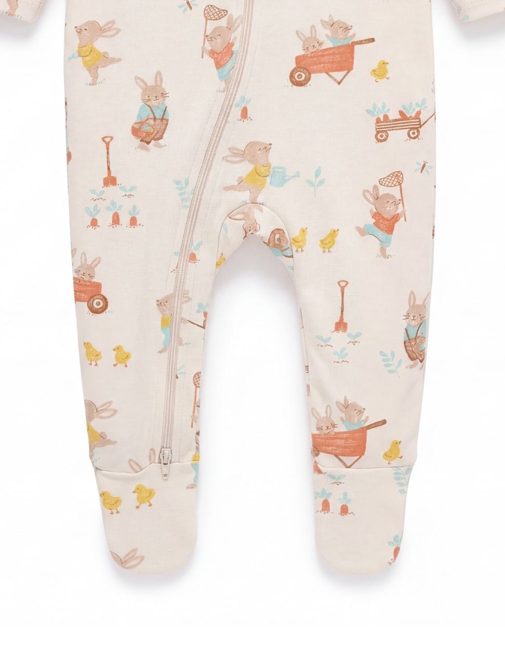 Close-up of the footed legs on an organic cotton Easter bunny zipper baby romper.