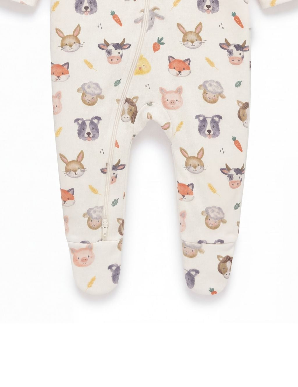 Close-up of the footed legs on a white organic cotton farm animal baby romper.