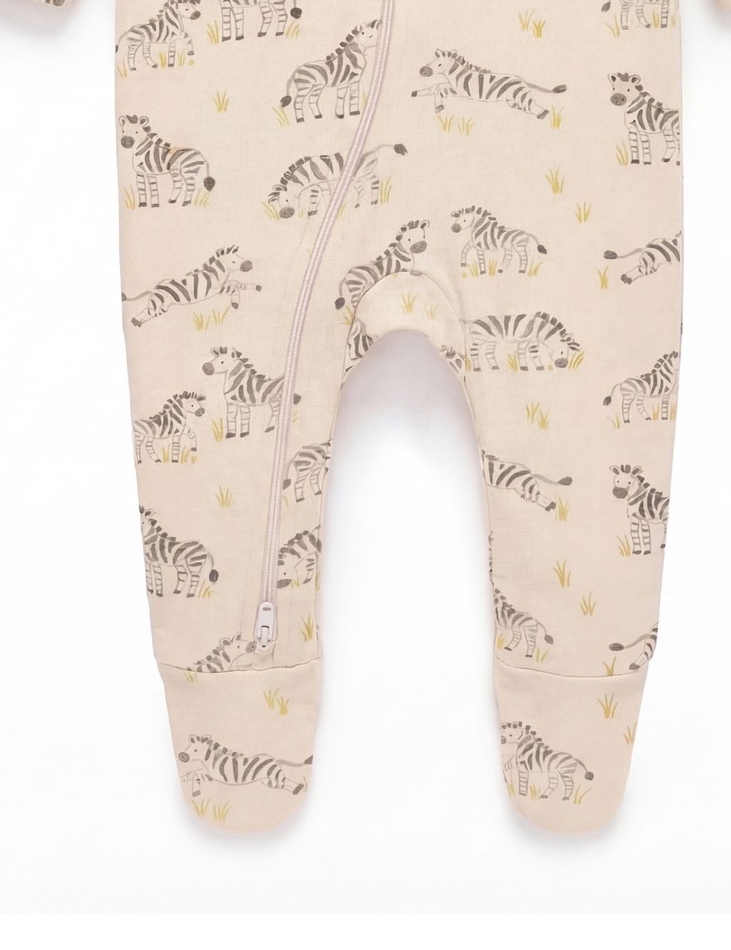Close-up of the footed legs on a cream organic cotton baby zipper romper with zebra prints.