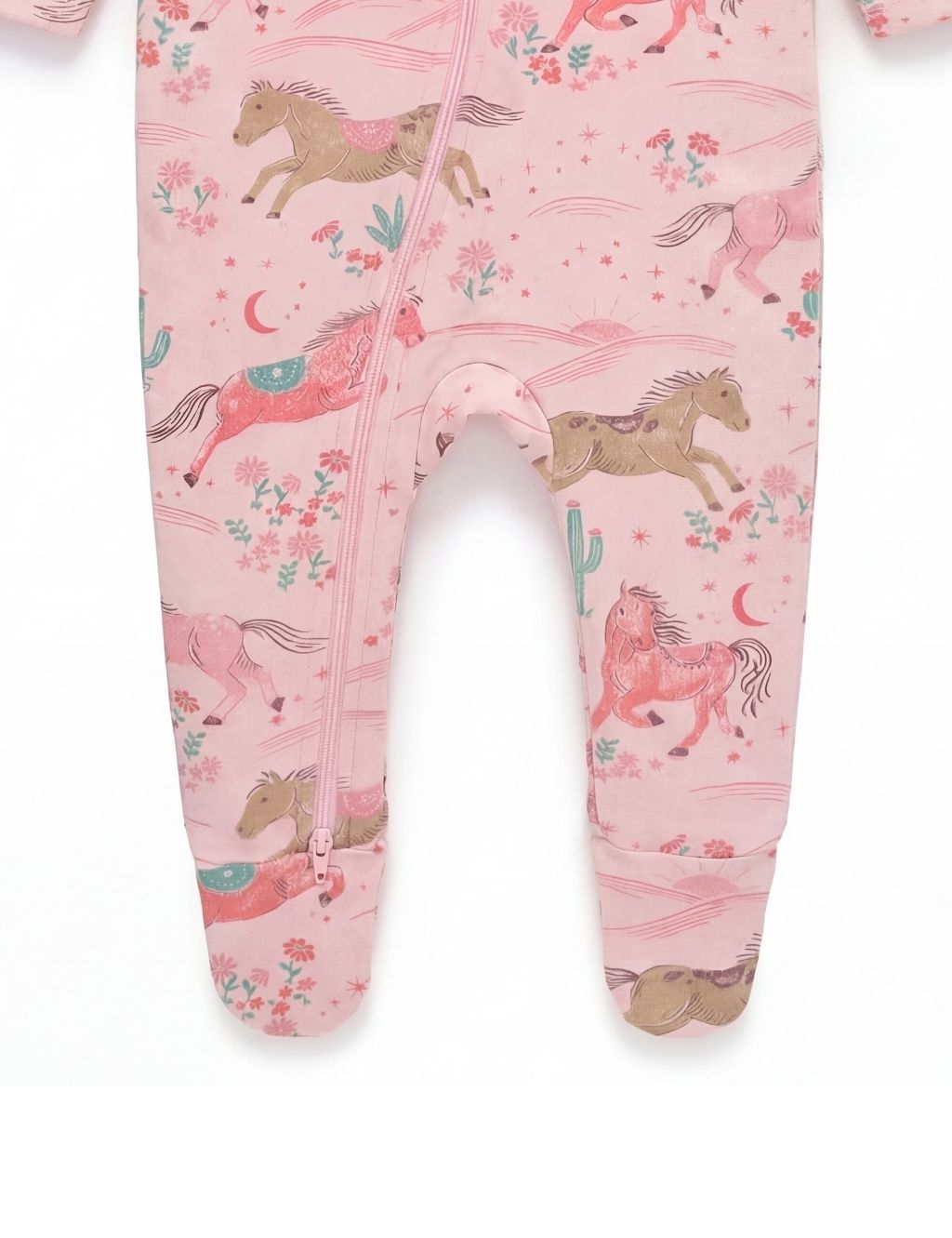 Close-up of the footed legs on a pink organic cotton desert horse baby romper.