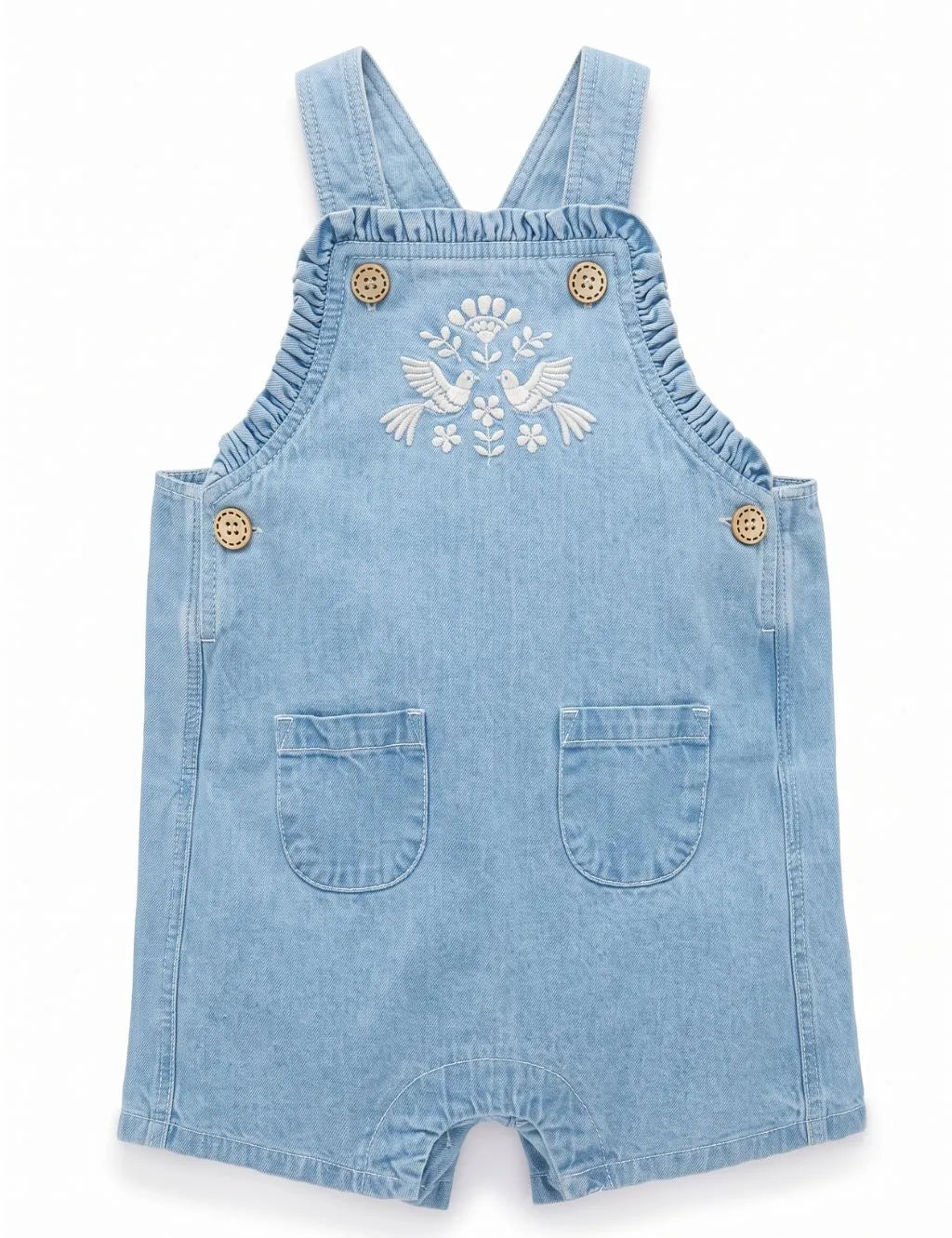 Front view of light wash denim short romper with bird embroidery, ruffled bib edge, and front pockets