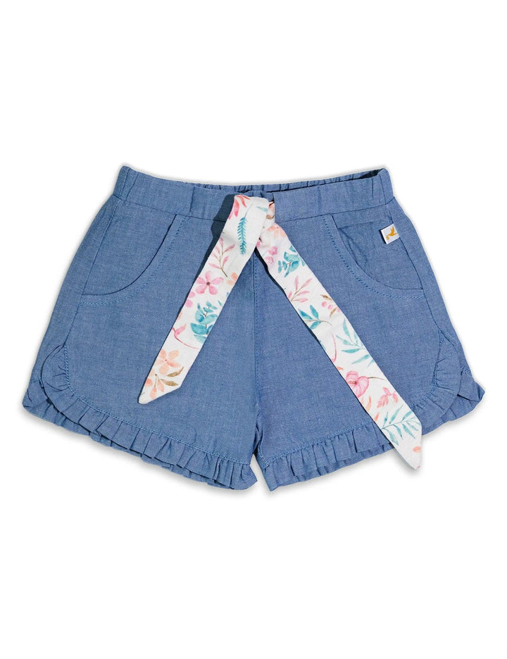 Alt Text: Detail of the denim-look baby shorts with a ruffled hem and a charming floral print sash tied at the waist. Shop stylish baby bottoms India.
