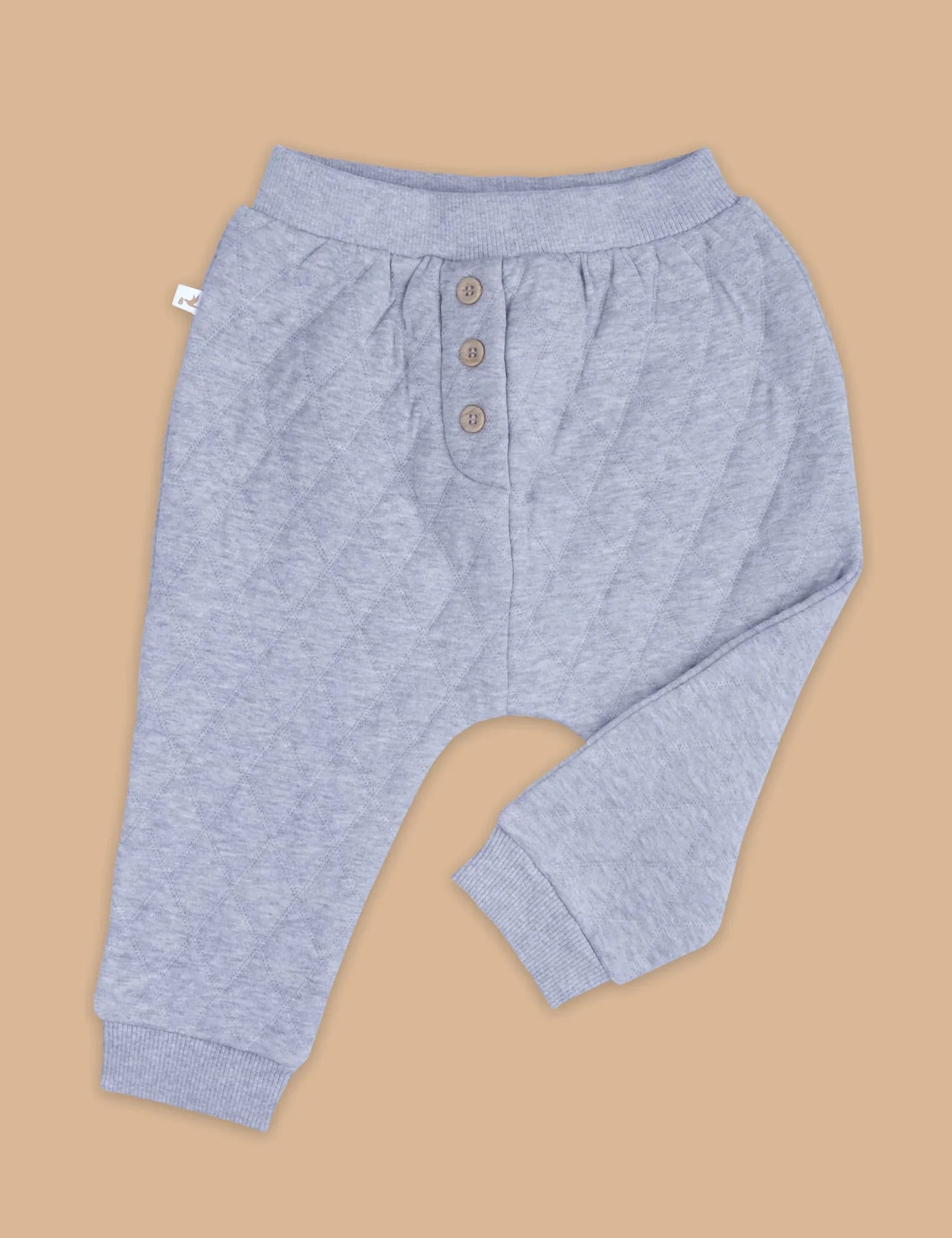 Light grey quilted slouchy track pants with ribbed waistband and cuffs, three buttons on front