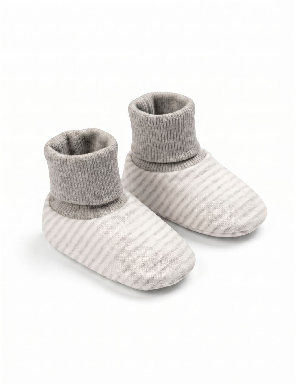 A pair of soft cream-colored baby booties featuring thin grey stripes and solid grey ribbed cuffs, displayed against a plain white background.