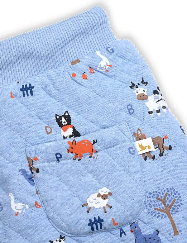 Light blue quilted baby pants with farm animal prints including cows, pigs, sheep, and dogs