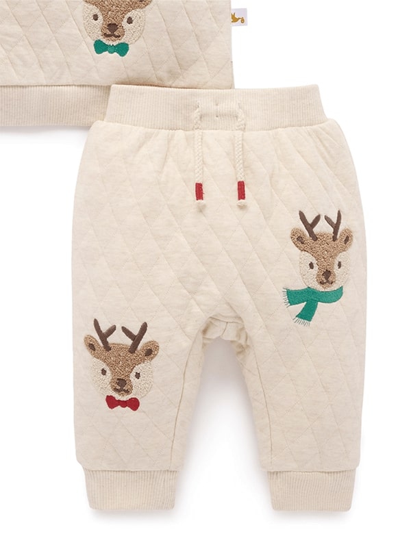 Children's outfit with quilted design featuring reindeer and bow ties on a white background