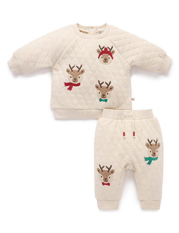 Children's outfit set with quilted top and pants featuring reindeer designs on a white background.