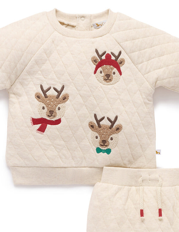 Children's sweater with reindeer designs on a white background