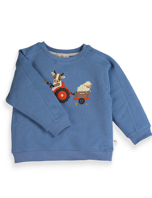 Blue kids sweatshirt with embroidered farm tractor driven by cow and sheep in trailer